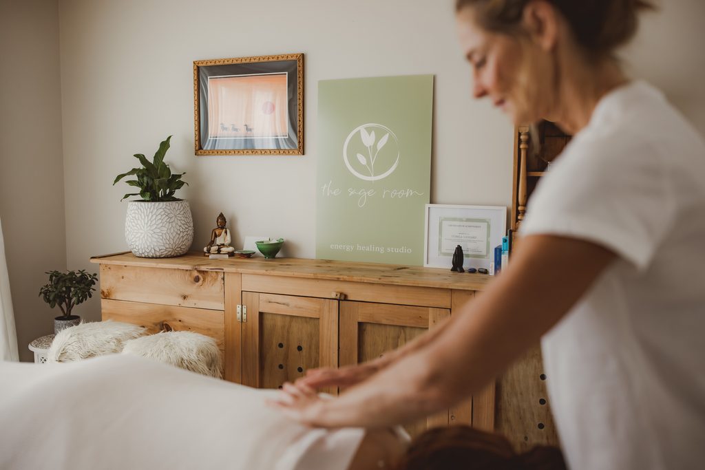 Behind the scenes personal branding photo of a therapist preparing a treatment room, natural light and wooden furniture